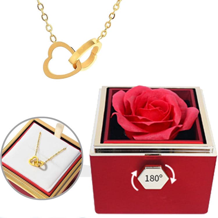 Gold interlocking-hearts necklace beside the red Rose Box, with a detail of the necklace in its open drawer